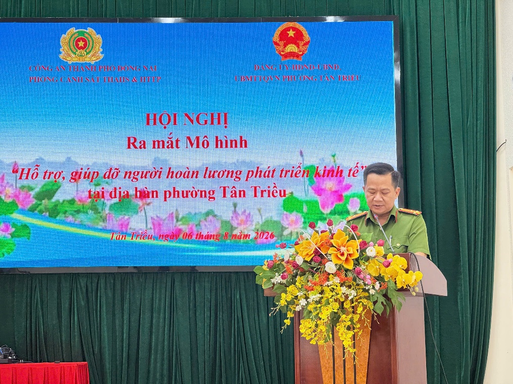 ''''''''A person standing at a podium with flowers

Description automatically generated''''''''